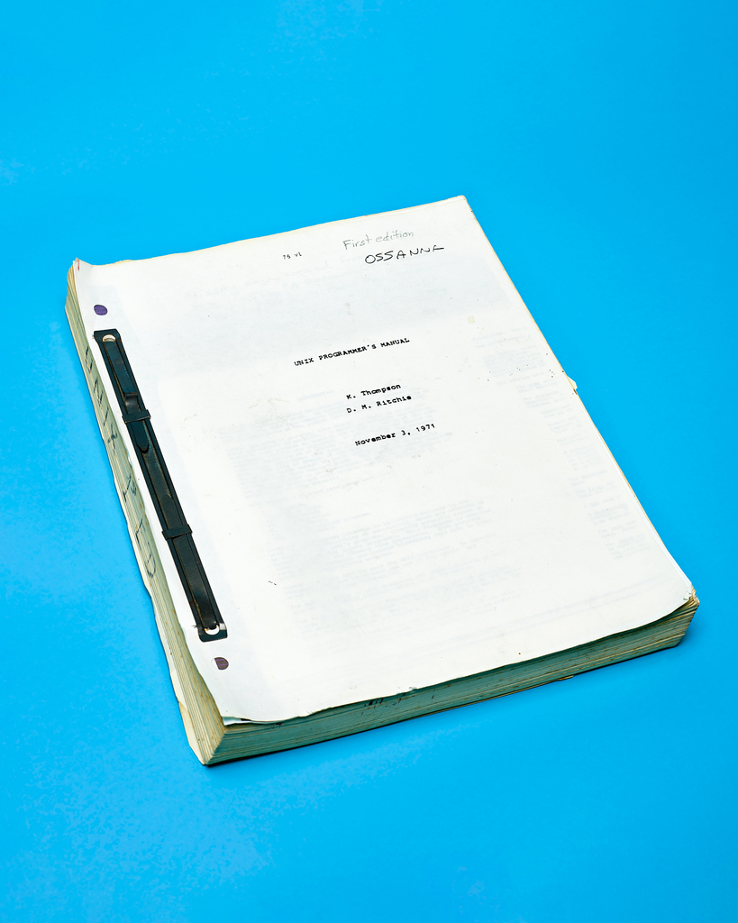 Unix Programer's Manual (1st  Edition) by Peter Adams. 