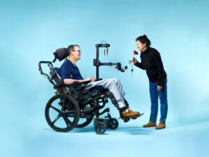 Henry Evans Gives His Wife A Rose. flower, robot, robotics, rose, tech.